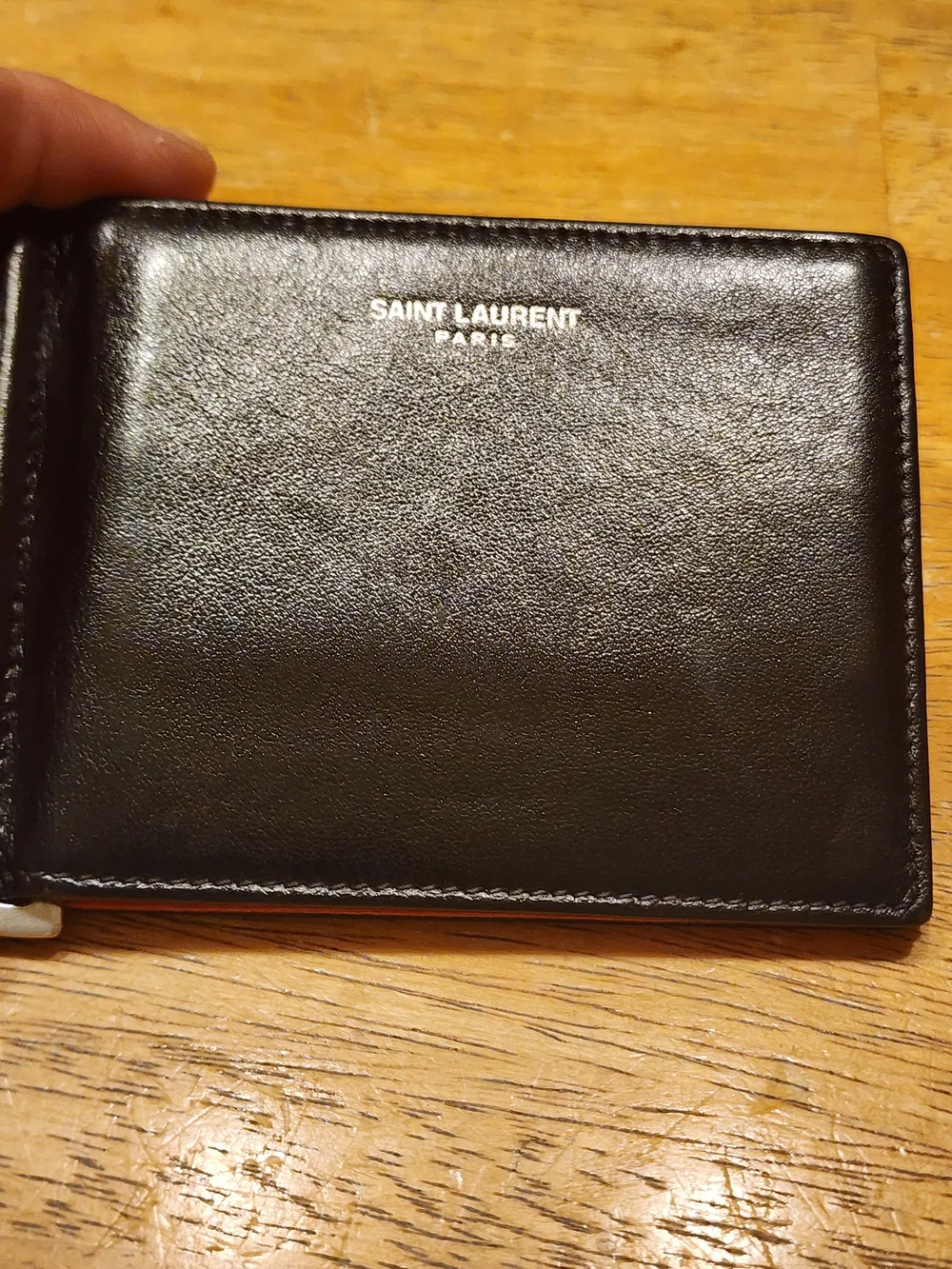 Saint Laurent wallet features a distinctive paisley bandana print on interior